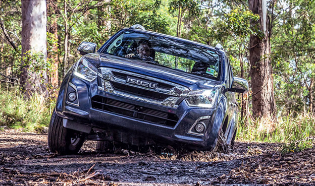 Isuzu Ute drives on muddy forest track