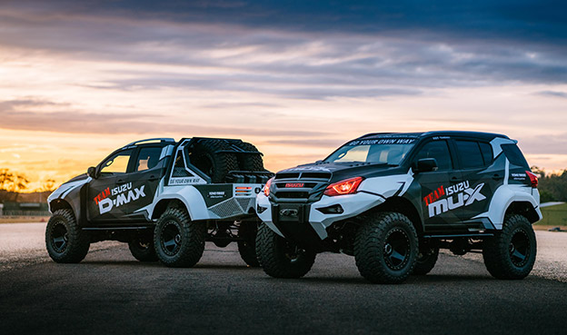 Two Concept X Team Isuzu Utes parked on a cliff 