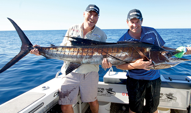 Nick Duigan and Andrew Hart pose with fish caught on boat